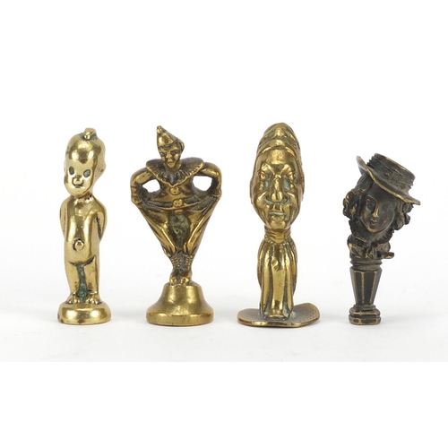 57 - Four antique pipe tampers including a pierrot design example, the largest 7cm high