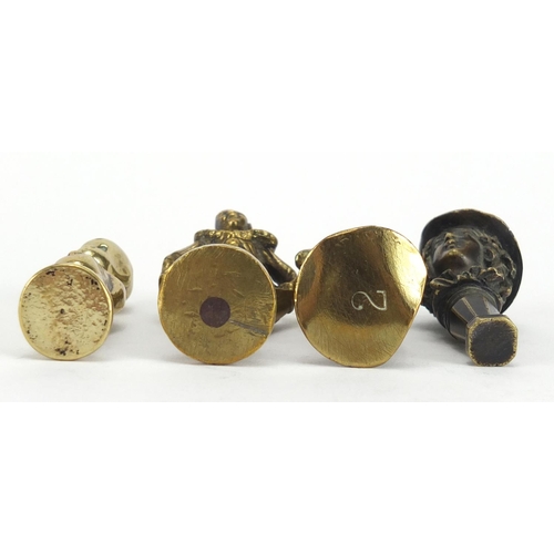 57 - Four antique pipe tampers including a pierrot design example, the largest 7cm high