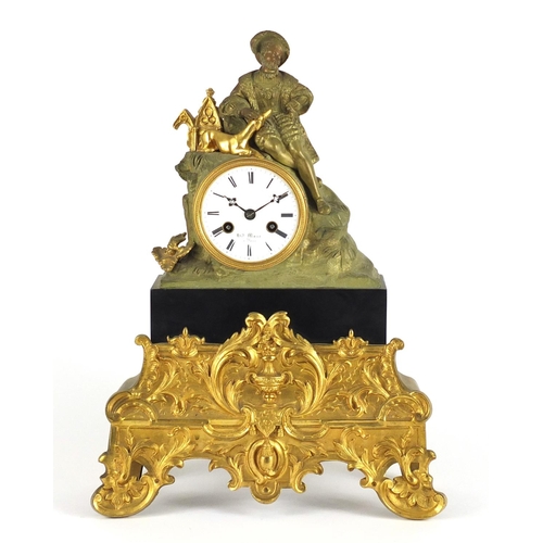 709 - 19th century French ormolu mantel clock, mounted with a man his dog, the enamelled dial with Roan nu... 