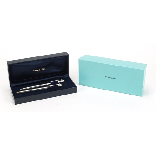 82 - Tiffany & Co silver propelling pencil and ball point pen, housed in a fitted case with box