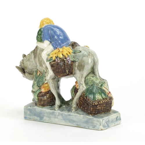 471 - Stella R Crofts hand painted pottery model of a figure on donkey, 18.5cm high