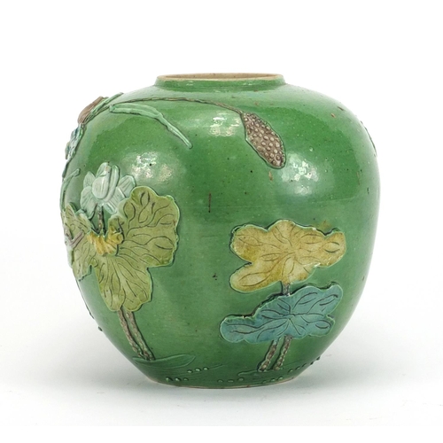 224 - Chinese porcelain green glazed jar, decorated in relief with a craned amongst flowers and reeds, 15.... 