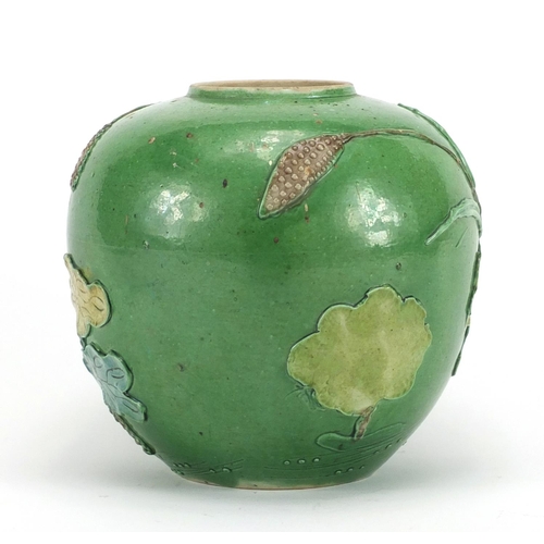 224 - Chinese porcelain green glazed jar, decorated in relief with a craned amongst flowers and reeds, 15.... 