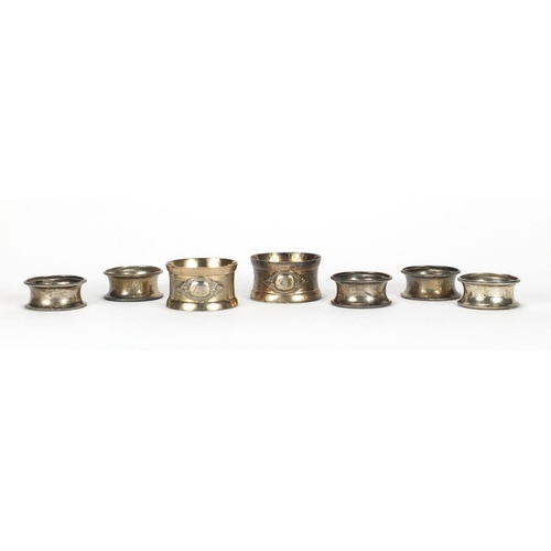 2540 - Set of five circular silver napkin rings and a pair of silver coloured metal napkin rings, approxima... 