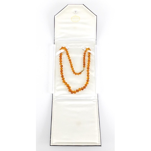 411 - Natural amber bead necklace with silver gilt clasp