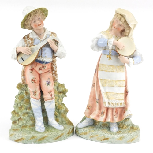 238 - Pair of continental bisque figures playing musical instruments, 37cm high