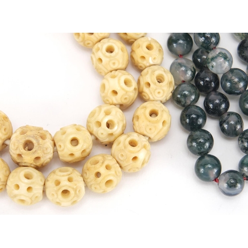 673 - Bead necklaces comprising carved bone, moss agate and Lapis Lazuli