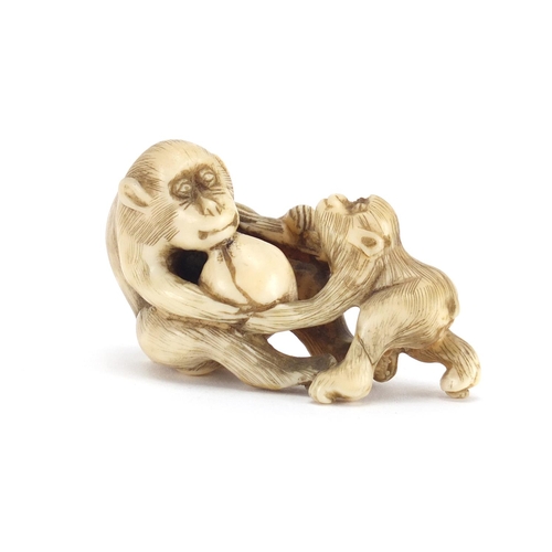 660 - Chinese carved ivory monkey with baby and fruit, 5.5cm in length
