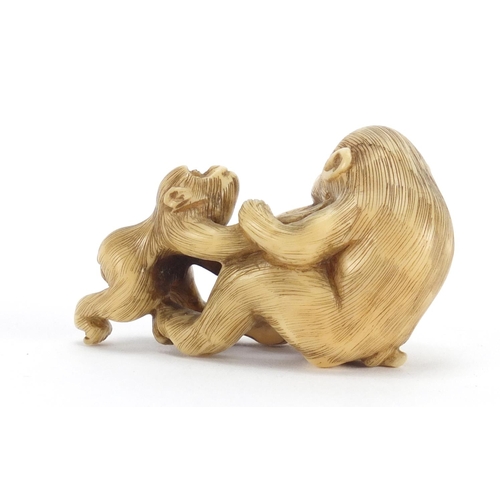 660 - Chinese carved ivory monkey with baby and fruit, 5.5cm in length