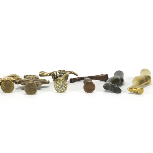 66 - Ten  antique pipe tampers including John Peel, Leg and hand design examples, the largest 8cm high