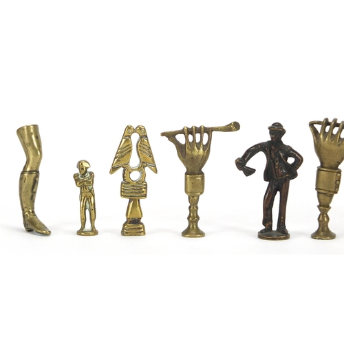 65 - Ten antique pipe tampers including figural, leg and Napoleon design examples, the largest 7cm high
