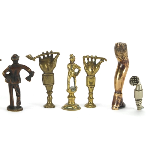 65 - Ten antique pipe tampers including figural, leg and Napoleon design examples, the largest 7cm high
