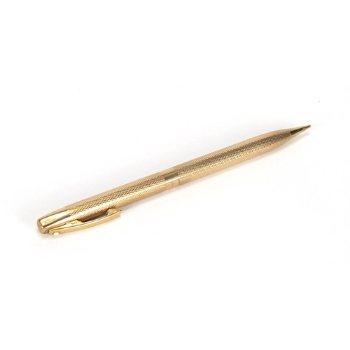 83 - 9ct gold Sheaffer propelling pencil with engine turned body, 13cm in length, approximate weight 19.8... 
