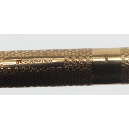 83 - 9ct gold Sheaffer propelling pencil with engine turned body, 13cm in length, approximate weight 19.8... 