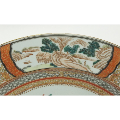 182 - Chinese porcelain iron red shallow charger, finely hand painted in the famille rose palette with fig... 