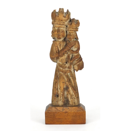 11 - 14th/15th century limewood carving of Madonna and child, raised on a rectangular mahogany block base... 