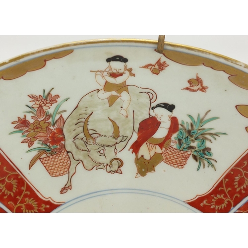 279 - Japanese Arita porcelain charger, hand painted with water buffalo's and figures in a landscape, 46cm... 