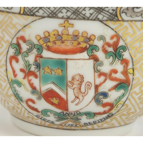 204 - Chinese porcelain armorial tea bowl and saucer hand painted with crests and flowers, the tea bowl 7.... 