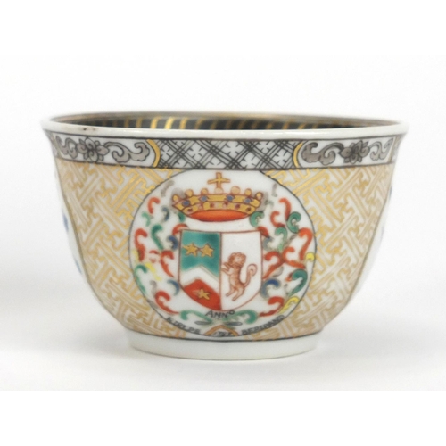 204 - Chinese porcelain armorial tea bowl and saucer hand painted with crests and flowers, the tea bowl 7.... 