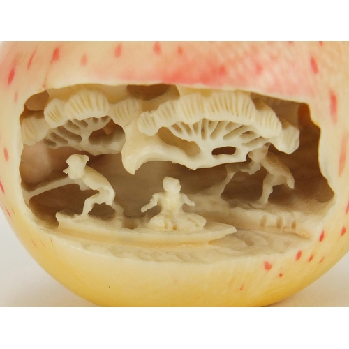 319 - Japanese stained ivory apple internally carved with fisherman, 4cm high