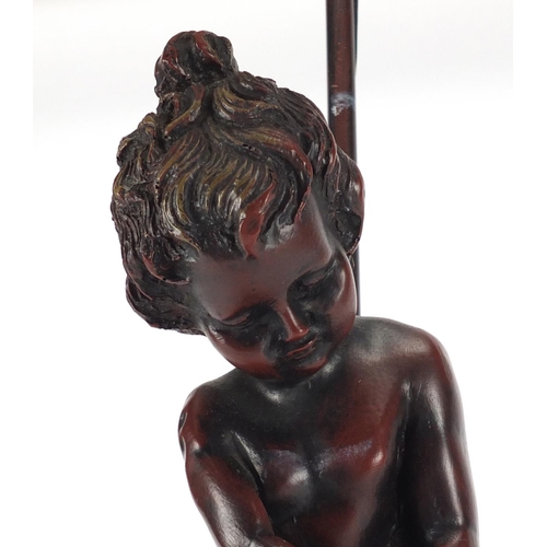 2178 - Art Nouveau style bronzed nude boy lamp with pink frilled glass shade, 56cm high