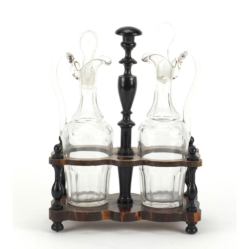 2339 - Pair of antique oil and vinegar decanters, housed in an ebonised stand, 28cm high