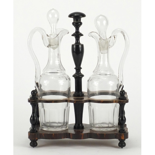 2339 - Pair of antique oil and vinegar decanters, housed in an ebonised stand, 28cm high