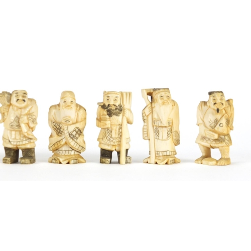 323 - Seven Japanese carved ivory Okimono's including two of farmers, one with character marks to the base... 