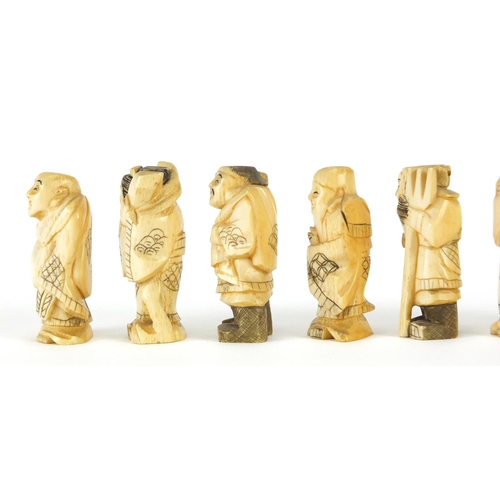 323 - Seven Japanese carved ivory Okimono's including two of farmers, one with character marks to the base... 