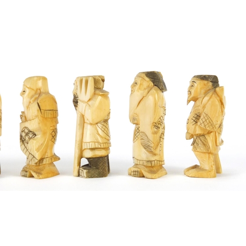 323 - Seven Japanese carved ivory Okimono's including two of farmers, one with character marks to the base... 