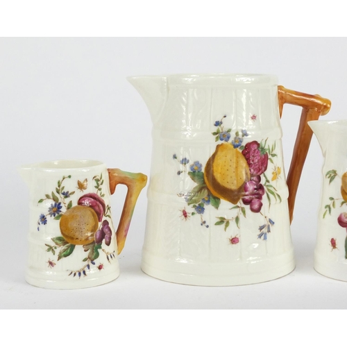 408 - ** DESCRIPTION AMENDED 10/7 ** Graduated set of three Royal Worcester naturalistic jugs, decorated w... 