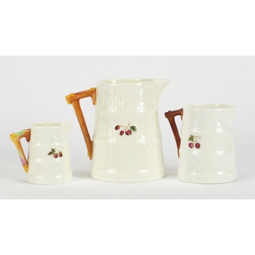 408 - ** DESCRIPTION AMENDED 10/7 ** Graduated set of three Royal Worcester naturalistic jugs, decorated w... 