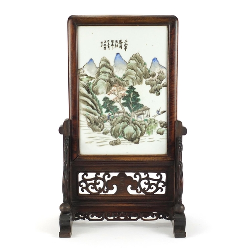 210 - Chinese hardwood table screen housing a porcelain panel hand painted with figures in a river mountai... 