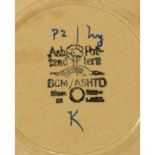 469 - Two Ashtead pottery plates including one hand painted with stylised foliage, each with factory marks... 