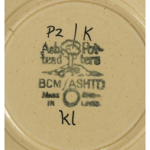 469 - Two Ashtead pottery plates including one hand painted with stylised foliage, each with factory marks... 