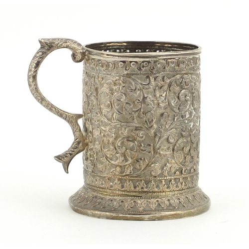 554 - Middle Eastern unmarked silver tankard profusely embossed with flowers, engraved Souvenir de Maugo E... 