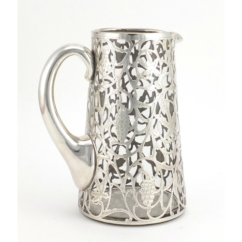 574 - Art Nouveau silver overlaid glass jug, decorated with fruiting vines, 19.5cm high