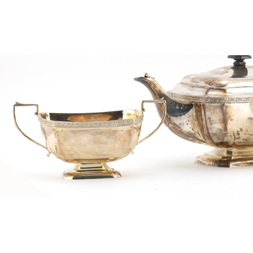 528 - Silver three piece tea set, by John Taylor & Co, Birmingham 1938, the teapot 30cm in length, approxi... 