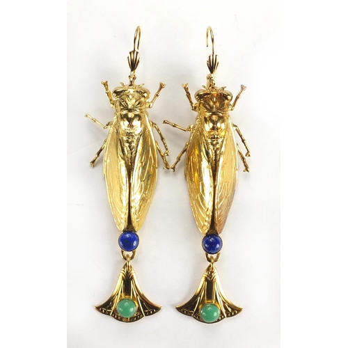 509 - Pair of Egyptian Revival gilt metal locust design earrings with drops and a pendant, 9cm high