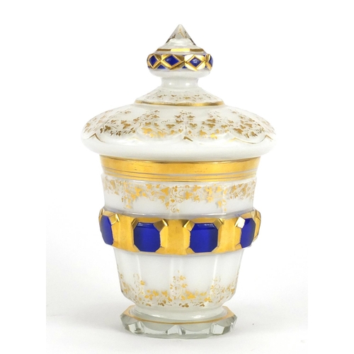 437 - Antique Biedermeier white overlaid glass bomboniere and cover gilded with foliage, 19cm high