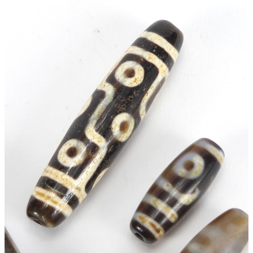 366 - Five Islamic agate beads, the largest 6cm in length
