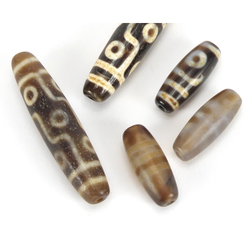 366 - Five Islamic agate beads, the largest 6cm in length