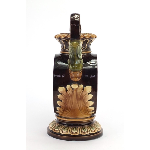 715 - Continental pottery mantel clock in the form of vase with twin dolphin handles, the enamelled dial w... 