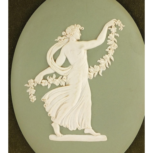 414 - Two Wedgwood green Jasper Ware plaques including one of a maiden, each in a gilt frames, impressed m... 