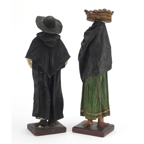 12 - Pair of carved wood and plaster figures of peasants, the largest 38.5cm high