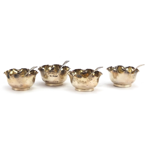 575 - Set of four circular silver open salts with spoons, by Atkin Brothers Sheffield 1902, housed in a fi... 