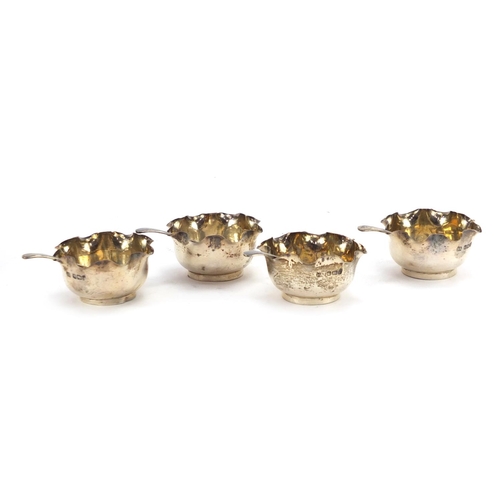 575 - Set of four circular silver open salts with spoons, by Atkin Brothers Sheffield 1902, housed in a fi... 