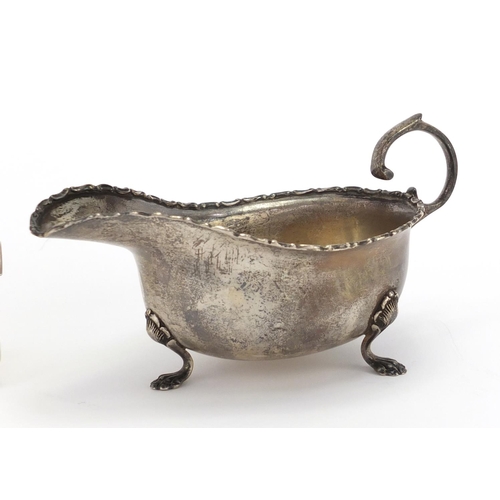 560 - Silver three footed sauce boat and two rectangular silver cigarette cases, various hallmarks, the sa... 