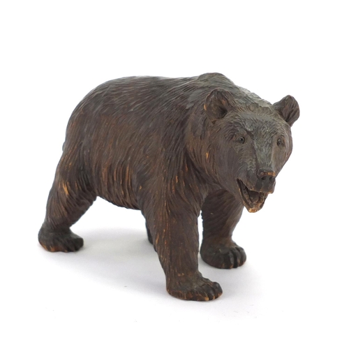 13 - Carved Black Forest standing bear with beaded glass eyes, 17cm in length