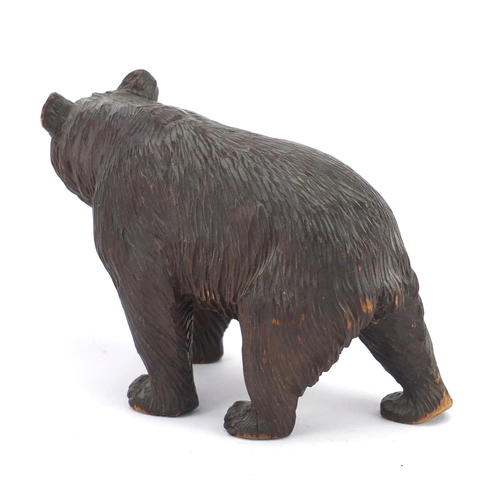 13 - Carved Black Forest standing bear with beaded glass eyes, 17cm in length